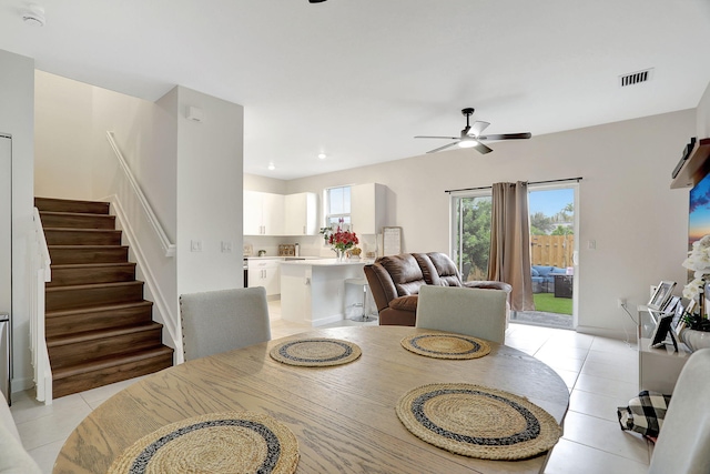 tiled dining room featuring ceiling fan