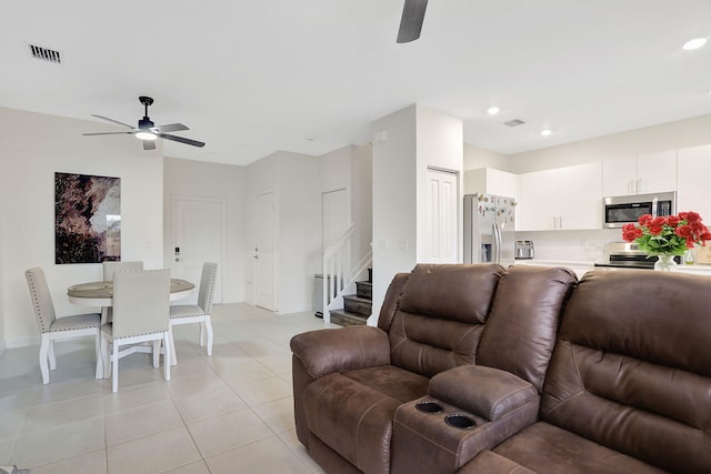 living room with ceiling fan and light tile patterned floors