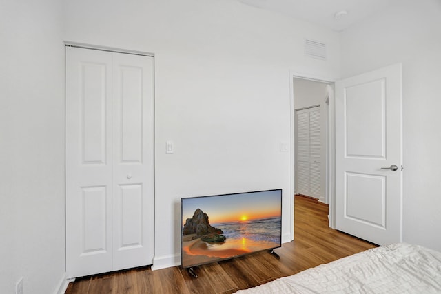 bedroom featuring hardwood / wood-style flooring and a closet