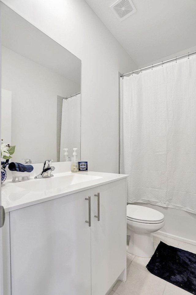 full bathroom with tile patterned floors, shower / bathtub combination with curtain, toilet, and vanity