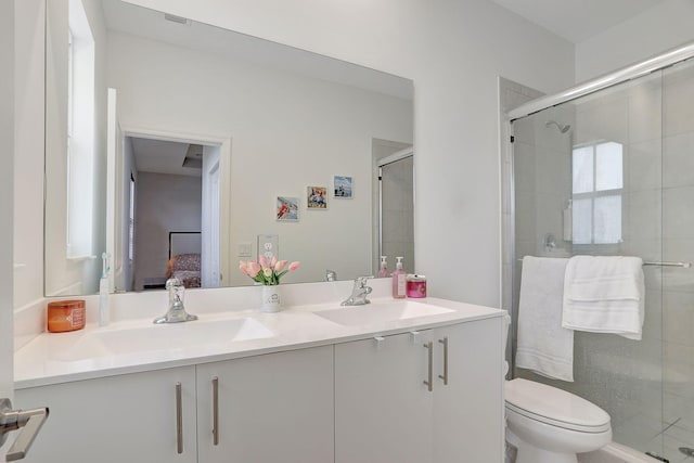 bathroom featuring vanity, toilet, and walk in shower