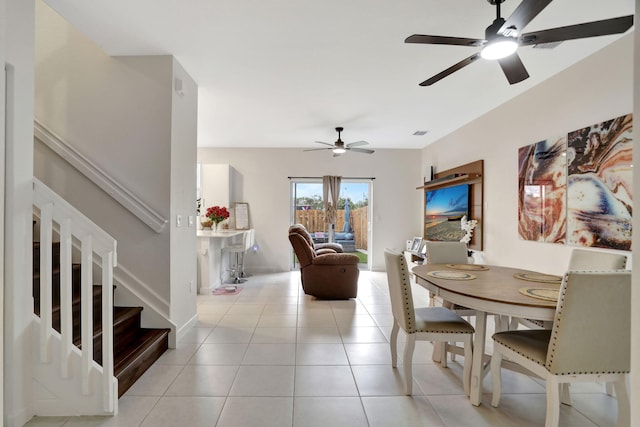 dining area with light tile patterned floors and ceiling fan