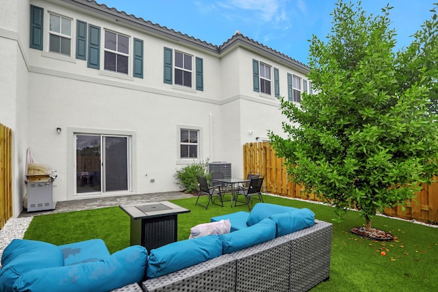 rear view of house with central AC, a lawn, and an outdoor hangout area