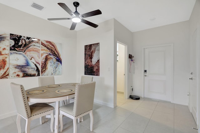 dining space with light tile patterned floors and ceiling fan