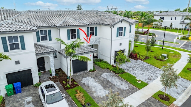 exterior space featuring a garage and a front lawn