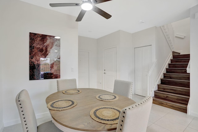 dining space with ceiling fan and light tile patterned flooring