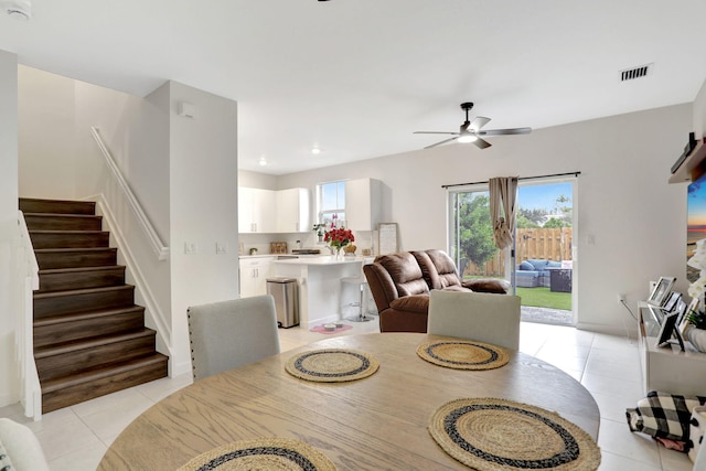 tiled dining space featuring ceiling fan