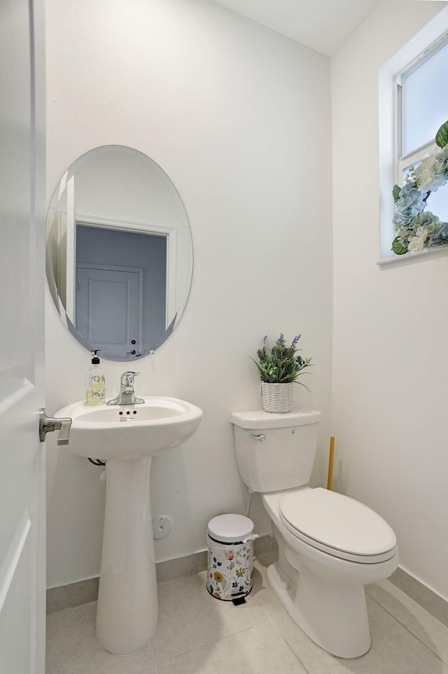 bathroom with toilet and tile patterned flooring