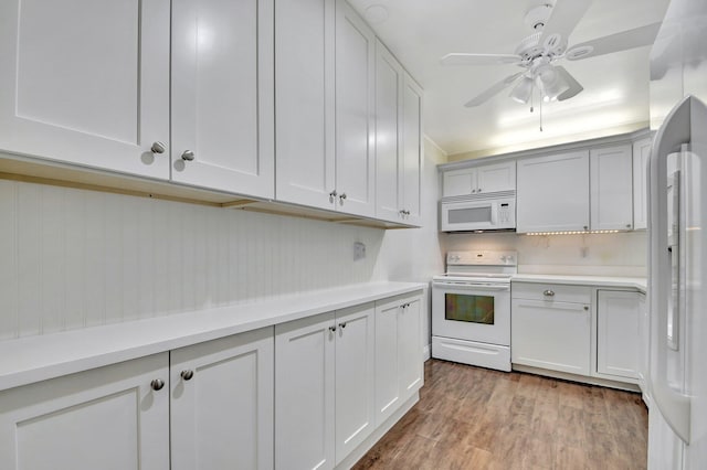 kitchen with white cabinets, ceiling fan, white appliances, and light hardwood / wood-style flooring