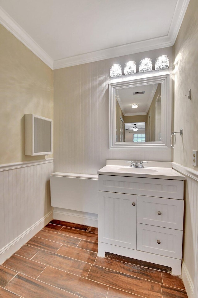 bathroom featuring vanity, crown molding, and ceiling fan