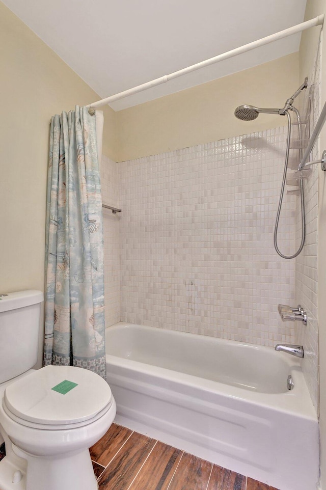 bathroom with shower / tub combo and toilet