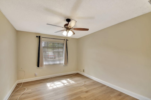 empty room featuring ceiling fan, a textured ceiling, and light wood-type flooring