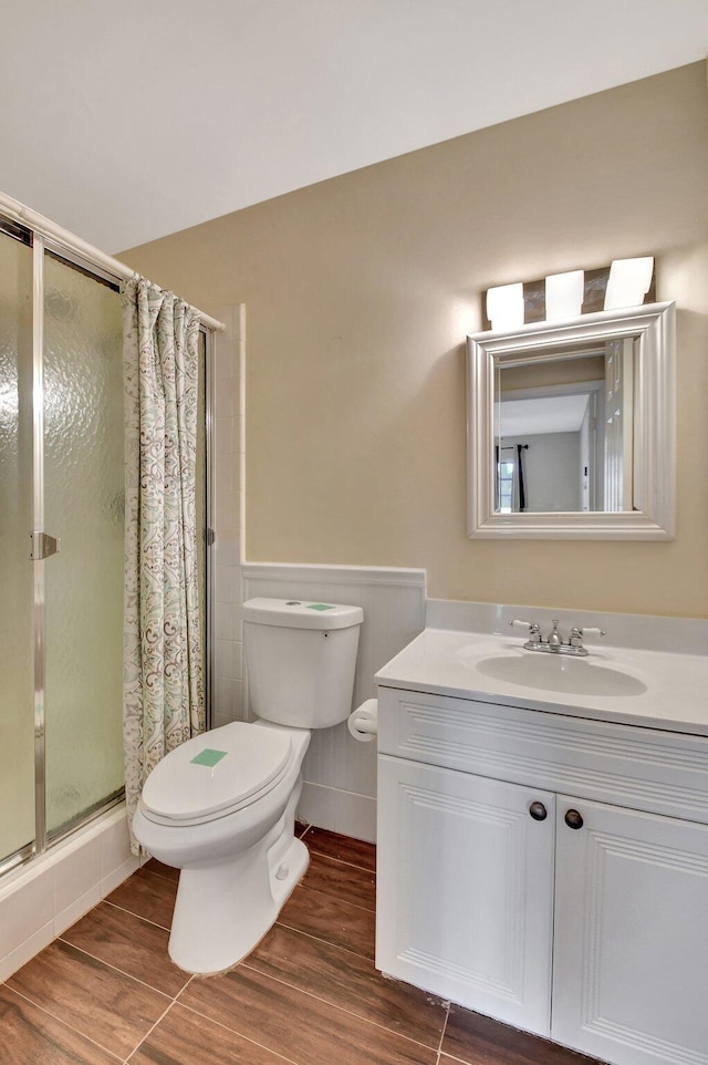 bathroom featuring a shower, vanity, and toilet