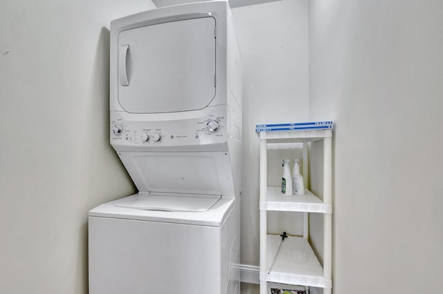 washroom featuring stacked washer / dryer