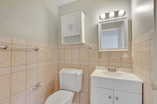 bathroom with vanity, toilet, decorative backsplash, and tile walls