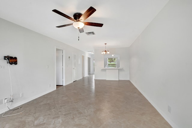 tiled empty room featuring ceiling fan with notable chandelier