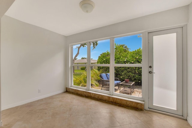 tiled empty room featuring plenty of natural light