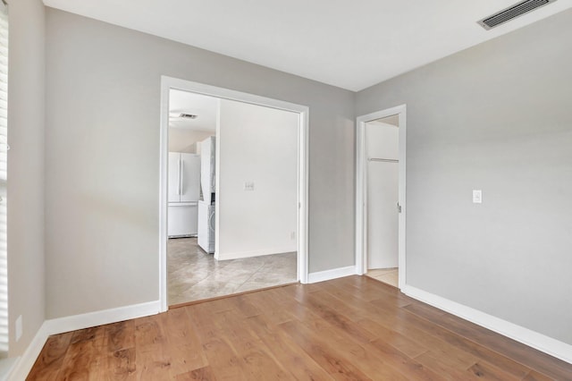 empty room with hardwood / wood-style floors