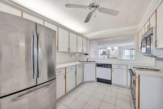 kitchen with pendant lighting, white appliances, ceiling fan with notable chandelier, a textured ceiling, and white cabinetry