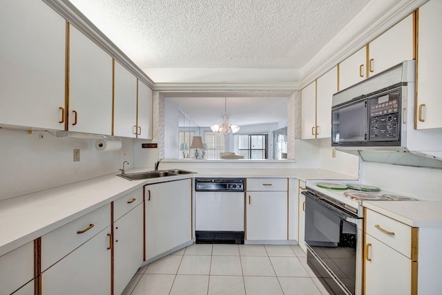 kitchen featuring pendant lighting, white cabinetry, white appliances, and a textured ceiling