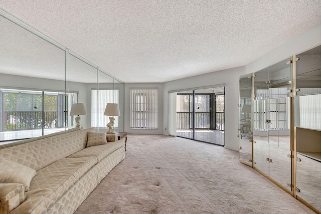 carpeted living room featuring a textured ceiling