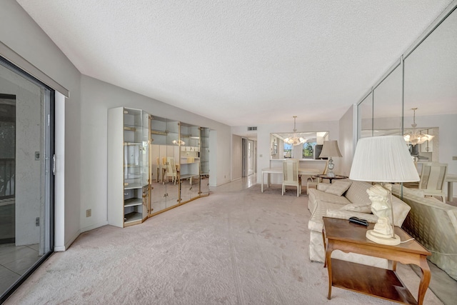 carpeted living room with a textured ceiling and an inviting chandelier