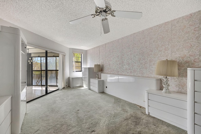 interior space with ceiling fan and a textured ceiling