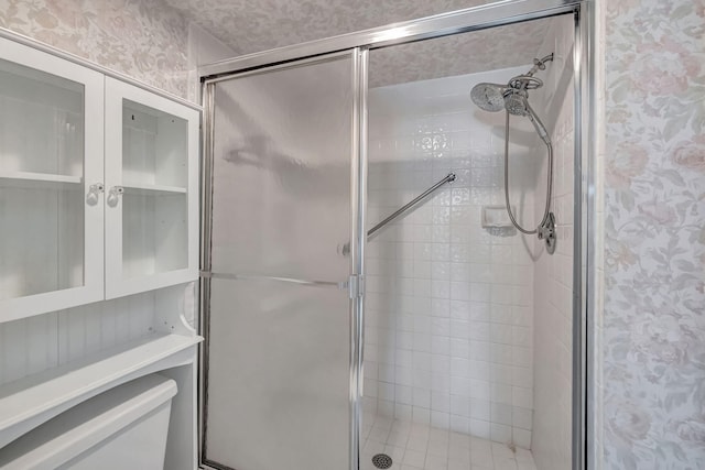 bathroom with a shower with door