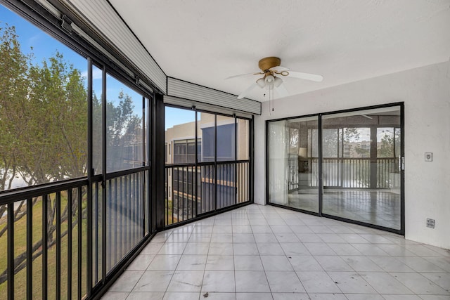 unfurnished sunroom featuring ceiling fan