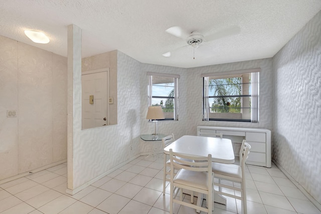 tiled dining area featuring a textured ceiling and ceiling fan