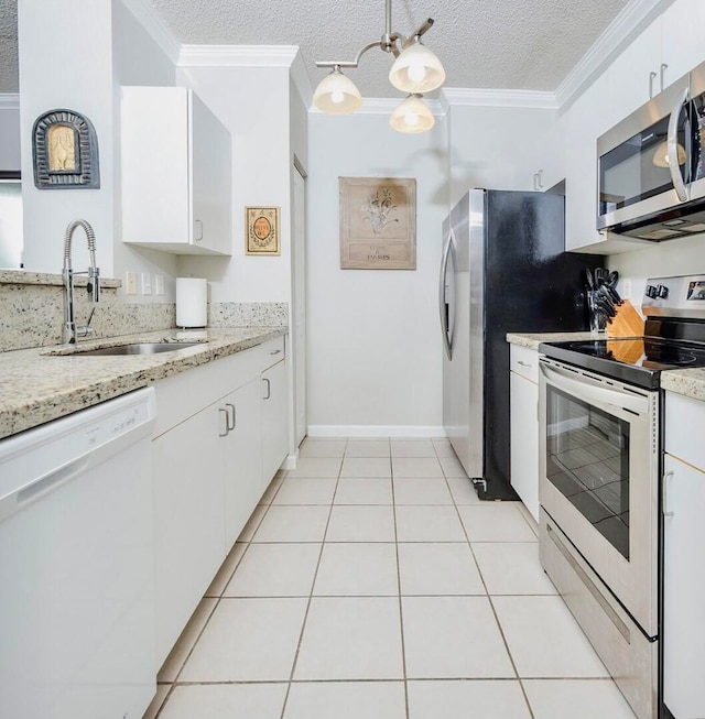 kitchen featuring a textured ceiling, stainless steel appliances, white cabinetry, and sink