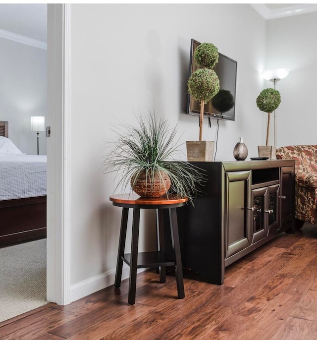 interior details featuring hardwood / wood-style flooring and ornamental molding