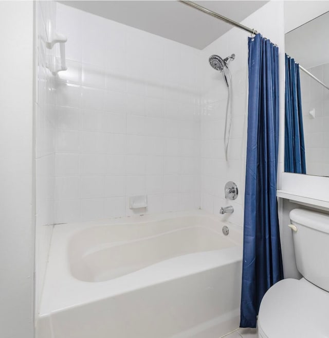 bathroom featuring shower / bath combo and toilet