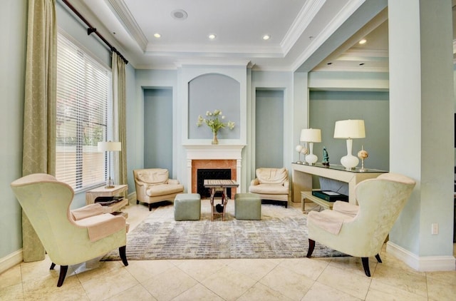 sitting room featuring a raised ceiling, crown molding, and light tile patterned flooring