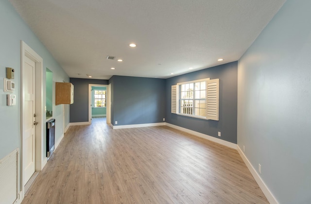 unfurnished living room featuring light hardwood / wood-style flooring