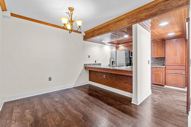 interior space with pendant lighting, dark hardwood / wood-style floors, wood ceiling, and ornamental molding