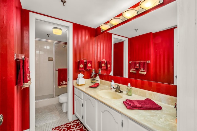 bathroom featuring vanity, tile patterned flooring, a shower with door, and toilet