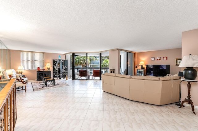 living room with a wall of windows and a textured ceiling