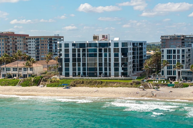 view of pool with a view of the beach and a water view