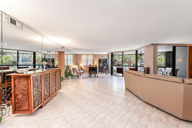 living room with a wall of windows and a textured ceiling