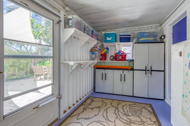 kitchen with white cabinets, a healthy amount of sunlight, and wooden ceiling