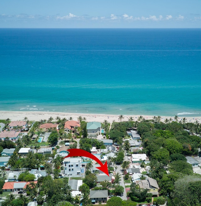 aerial view with a water view and a view of the beach