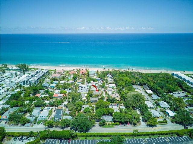 birds eye view of property featuring a beach view and a water view