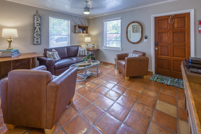 living room featuring ceiling fan, plenty of natural light, crown molding, and a textured ceiling