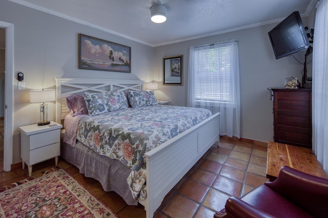 bedroom featuring ceiling fan, ornamental molding, and a textured ceiling