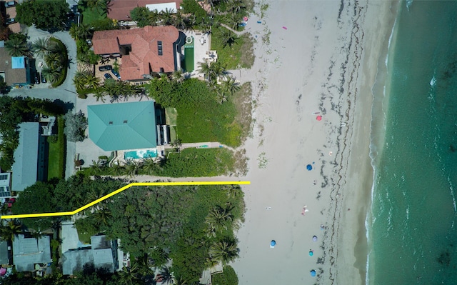 birds eye view of property with a water view and a view of the beach