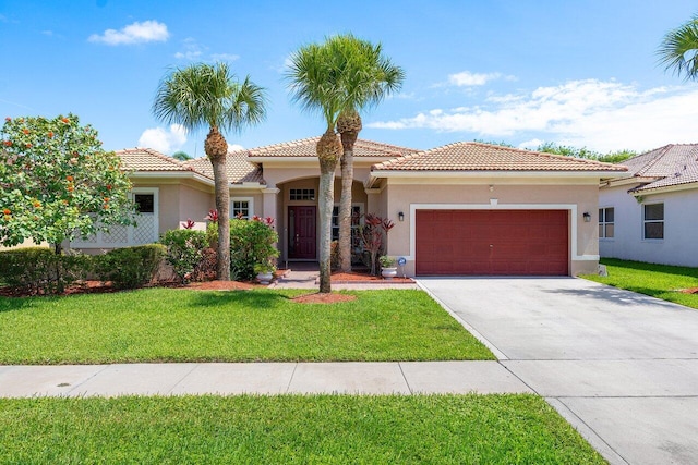 mediterranean / spanish house featuring a front lawn and a garage