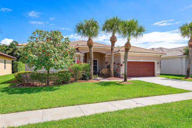 mediterranean / spanish-style home with a garage and a front lawn