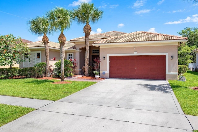 mediterranean / spanish house with a front lawn and a garage