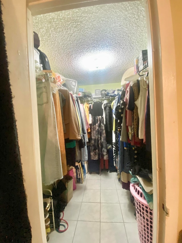 walk in closet featuring tile flooring